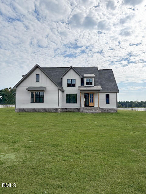 11214 Old Beulah Road Kenly, NC 27542 - Photo 1 of 21 a front view of a house with a garden