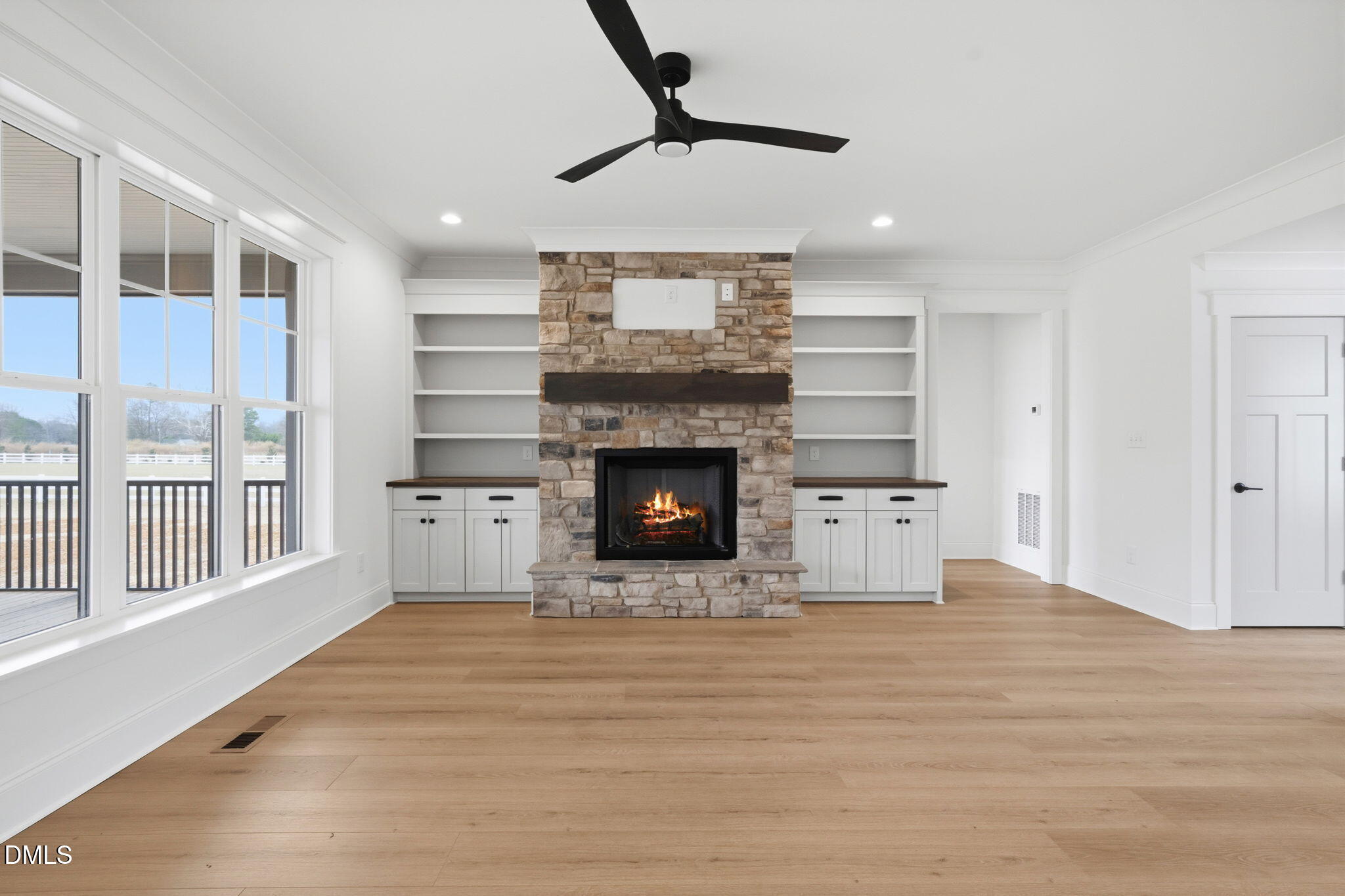 11214 Old Beulah Road Kenly, NC 27542 - Photo 12 of 56 a view of an empty room with a fireplace and a window