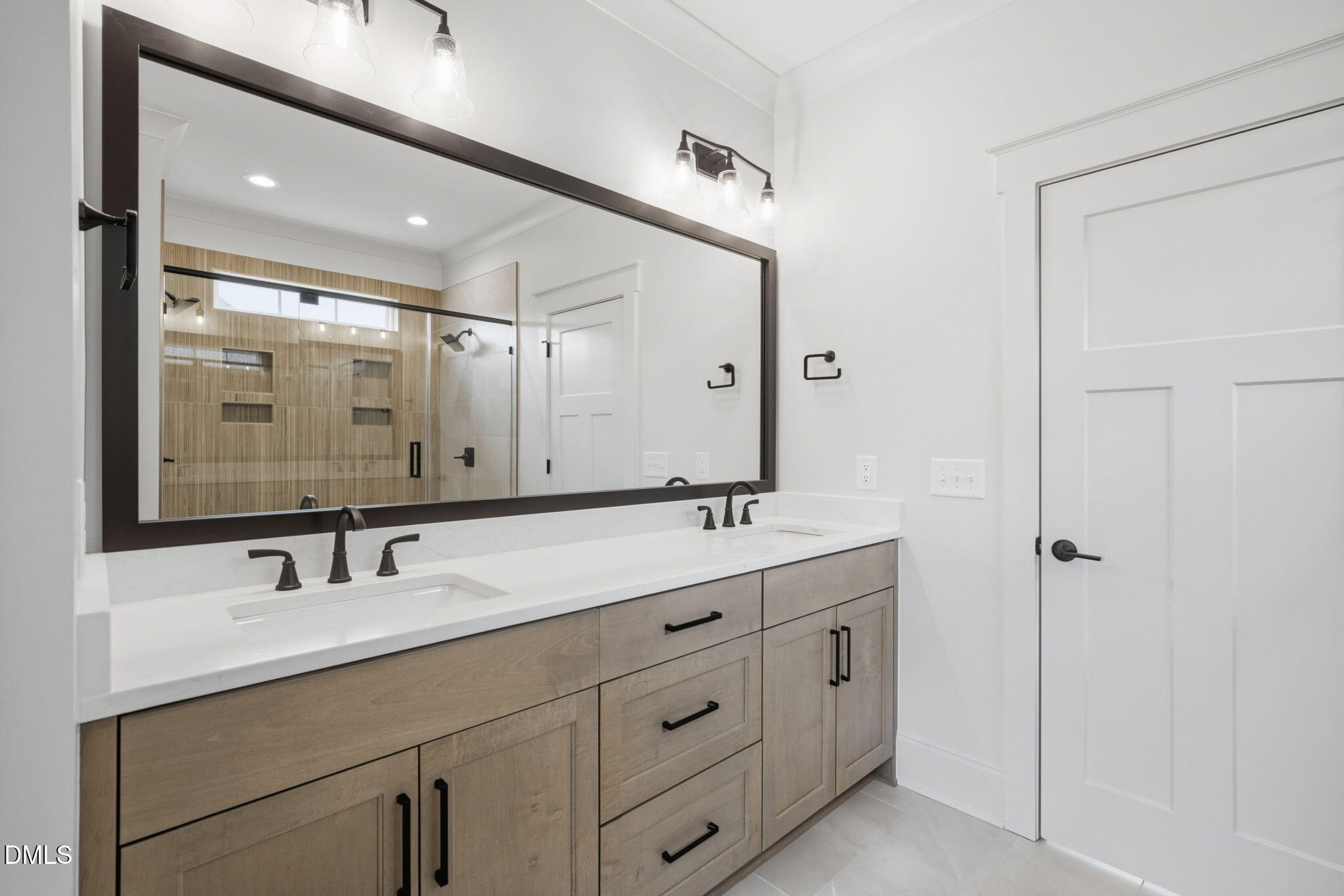 11214 Old Beulah Road Kenly, NC 27542 - Photo 28 of 56 a bathroom with double vanity sink and mirror