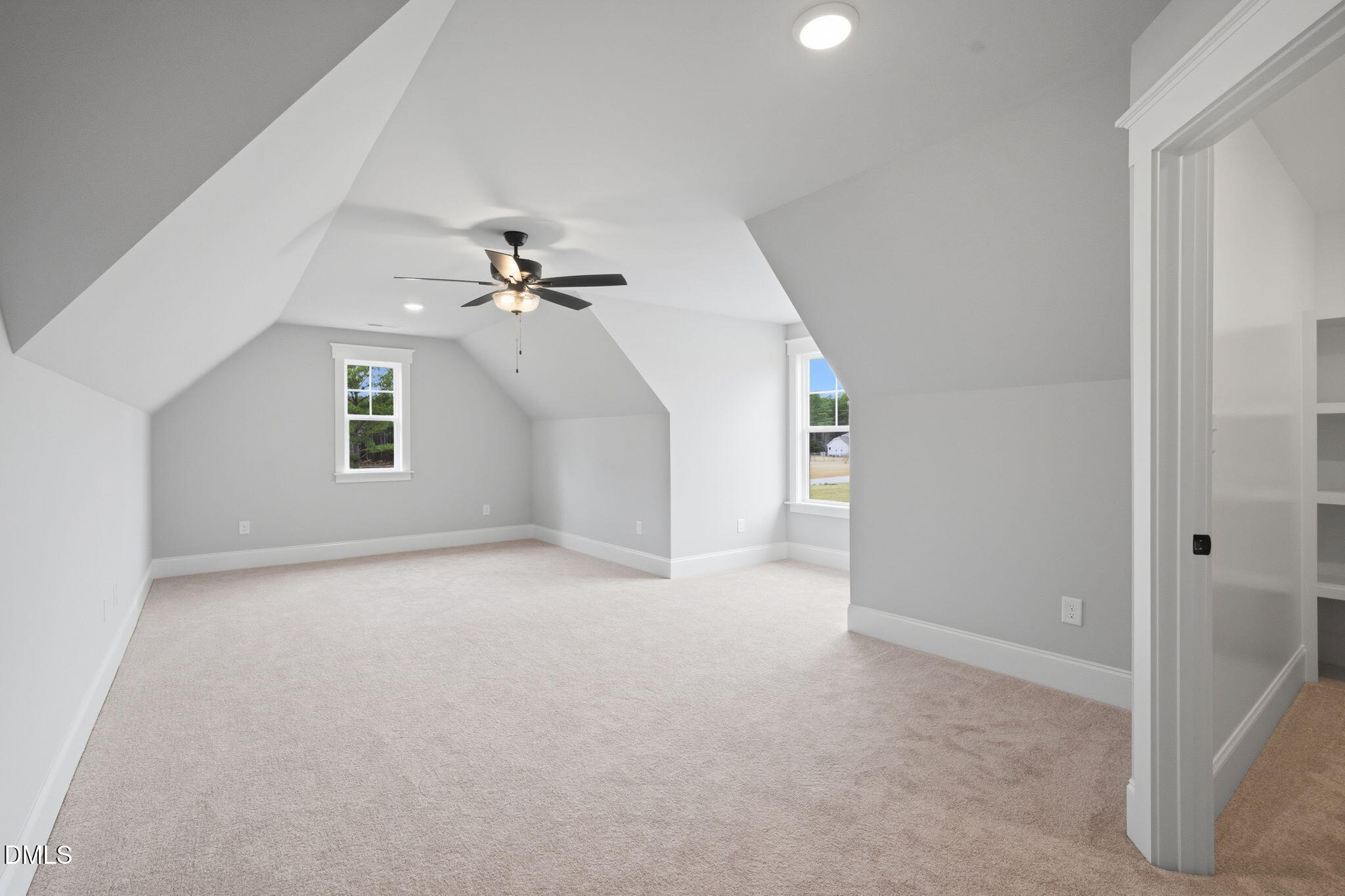 11214 Old Beulah Road Kenly, NC 27542 - Photo 44 of 56 an empty room with chandelier fan and windows