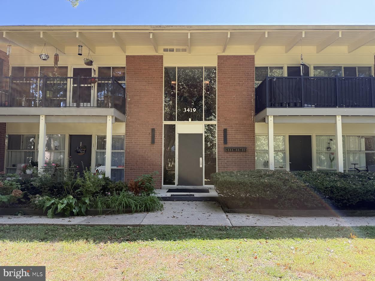 3419 University Boulevard West, Unit 203 Kensington, MD 20895 - Photo 1 of 25 a view of a building with a yard