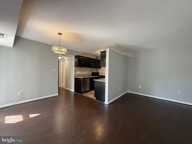 a view of kitchen with wooden floor and electronic appliances