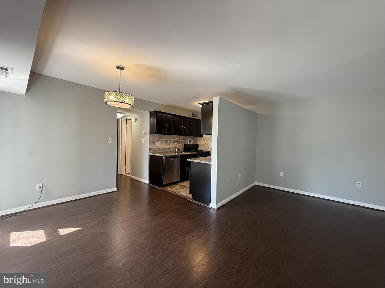 3419 University Boulevard West, Unit 203 Kensington, MD 20895 - Photo 11 of 25 a view of kitchen with wooden floor and electronic appliances