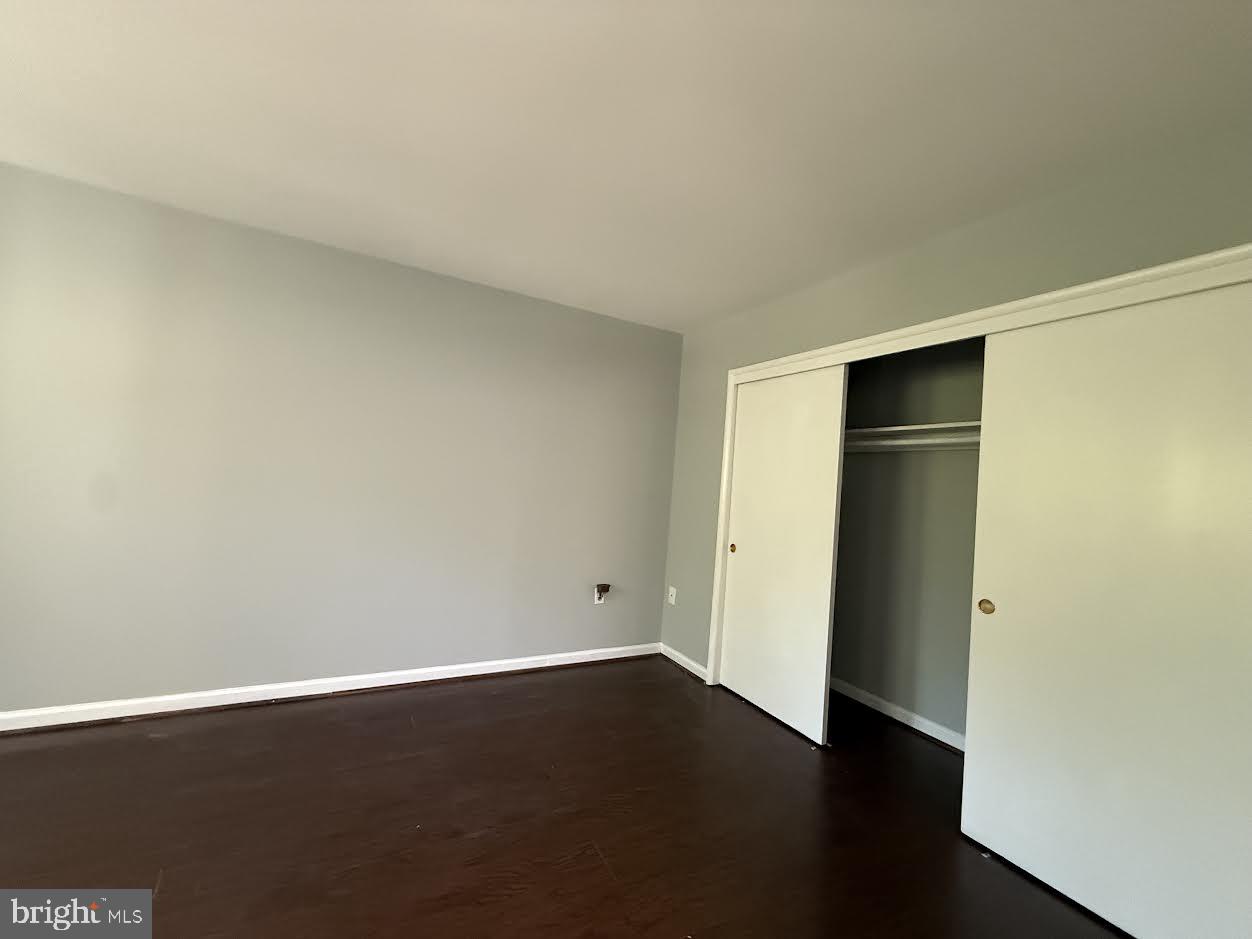 3419 University Boulevard West, Unit 203 Kensington, MD 20895 - Photo 15 of 25 an empty room with wooden floor and closet