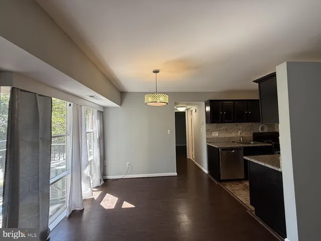 a kitchen with granite countertop a stove and a refrigerator