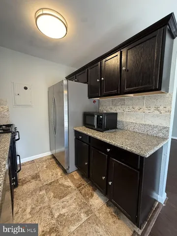 a kitchen with stainless steel appliances granite countertop a sink stove and microwave