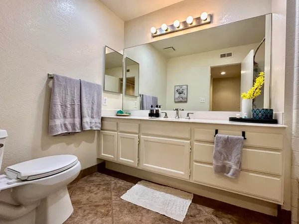 a bathroom with a sink a toilet and mirror