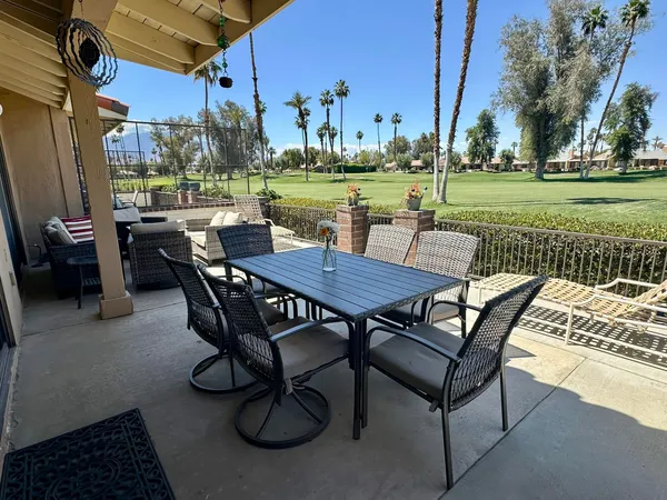a view of a patio with table and chairs