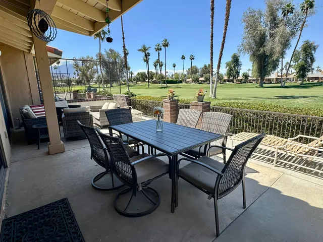 a view of a patio with table and chairs