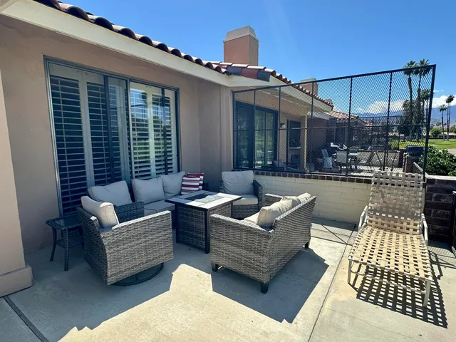 a view of a patio with couches and potted plants