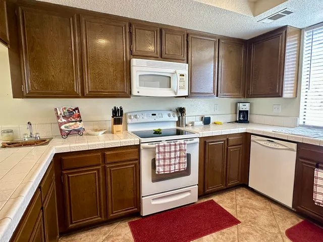 a kitchen with a sink cabinets and window