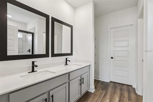 a bathroom with a double vanity sink and mirror