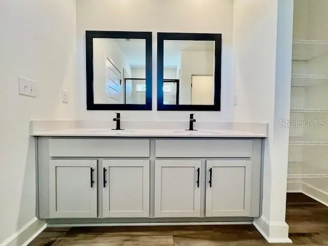 a bathroom with mirror sink and vanity