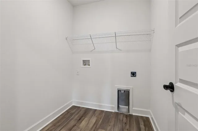 a view of a room with wooden floor and cabinet