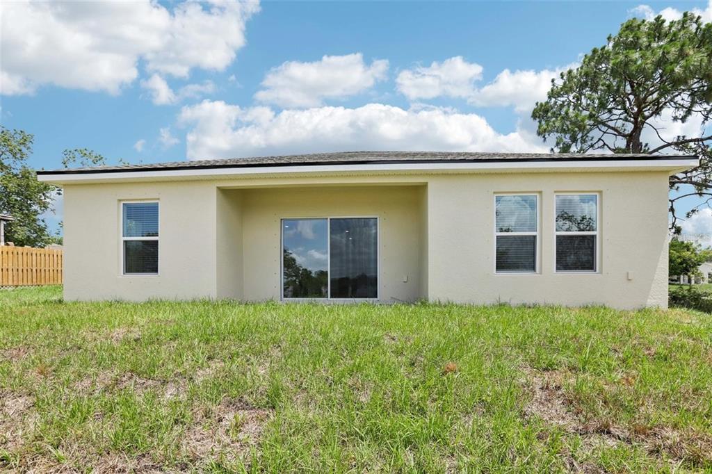 13112 Siam Drive Spring Hill, FL 34609 - Photo 42 of 46 a view of a house with a yard