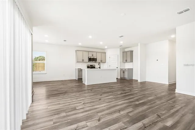 a view of a kitchen with wooden floor