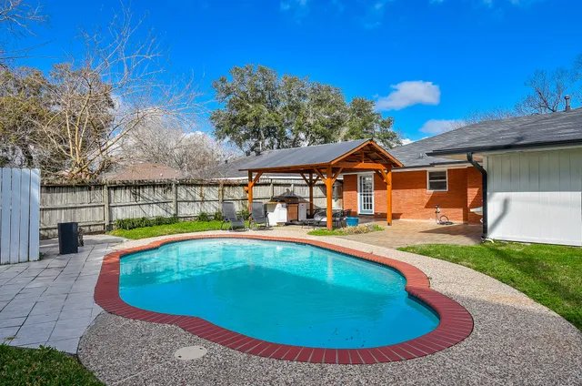 a view of a house with swimming pool and porch