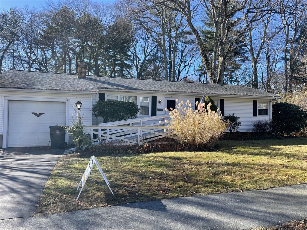 a view of a patio with table and chairs couches fire pit and large trees