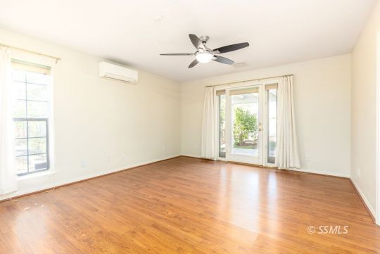 422 Vista Street Ridgecrest, CA 93555 - Photo 23 of 38 a view of an empty room with wooden floor and a window