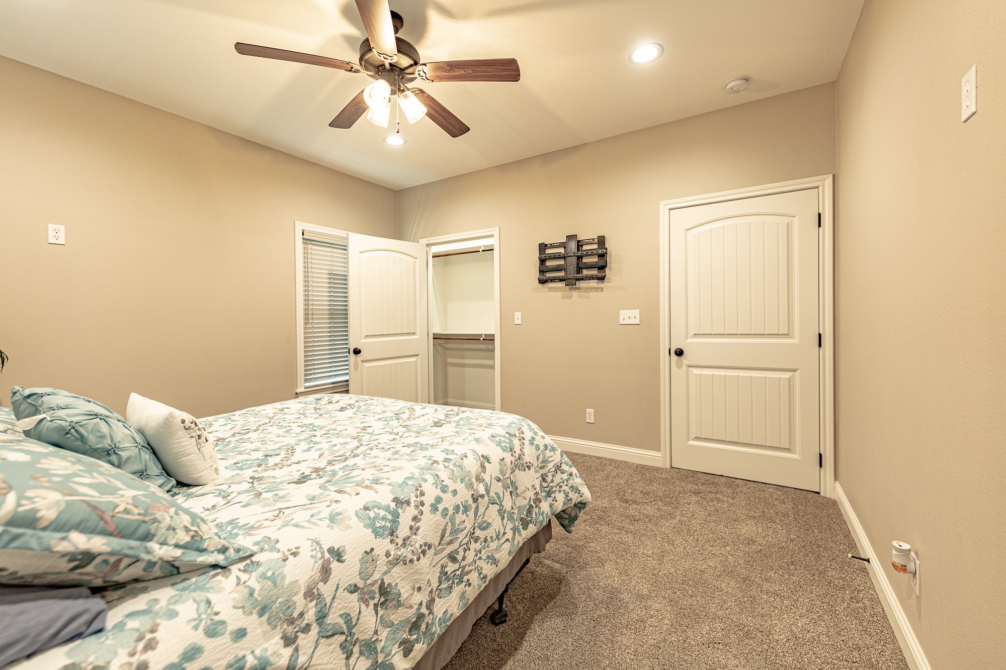 716 L Hrabovsky Road Yoakum, TX 77995 - Photo 15 of 42 a spacious bedroom with a bed and a chandelier