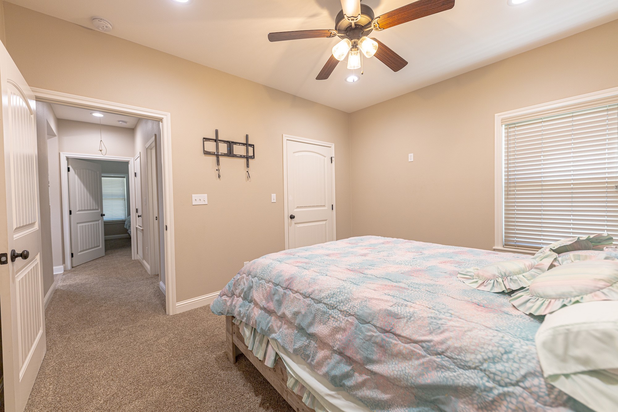 716 L Hrabovsky Road Yoakum, TX 77995 - Photo 18 of 42 a bedroom with a bed and a chandelier