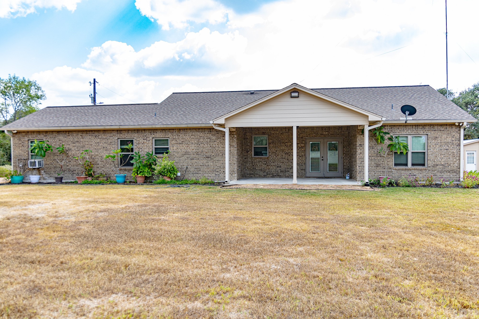 716 L Hrabovsky Road Yoakum, TX 77995 - Photo 22 of 42 a front view of a house with a garden and plants