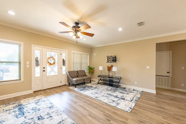 a living room with furniture and wooden floor