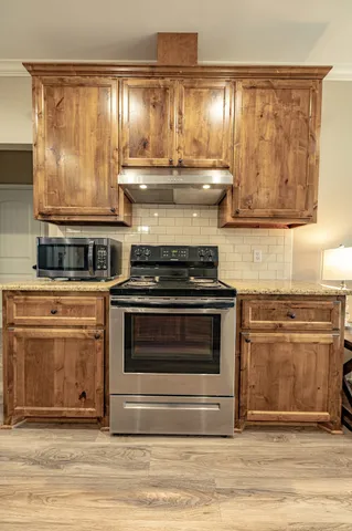 a stove top oven sitting inside of a kitchen