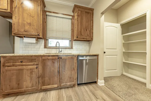 a kitchen with stainless steel appliances granite countertop a sink and cabinets