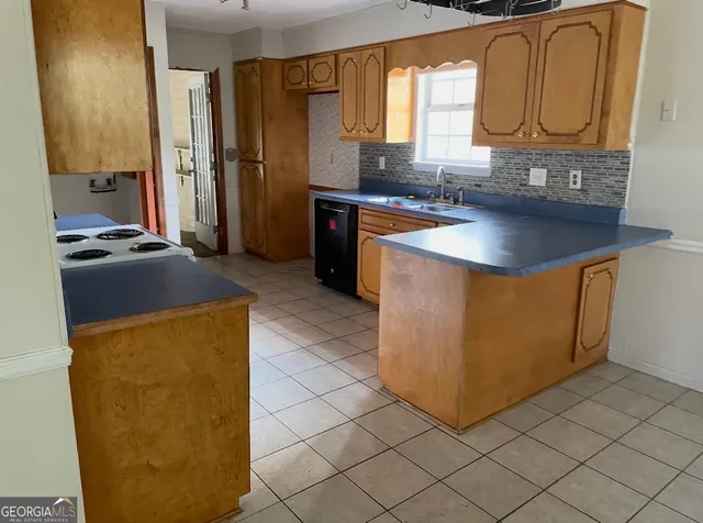a kitchen with stainless steel appliances granite countertop a sink and a refrigerator