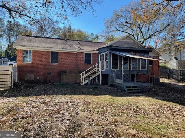 a view of a house with a yard covered with snow