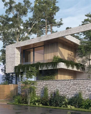a front view of a house with a yard and potted plants