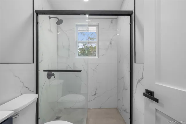 a bathroom with a shower and toilet
