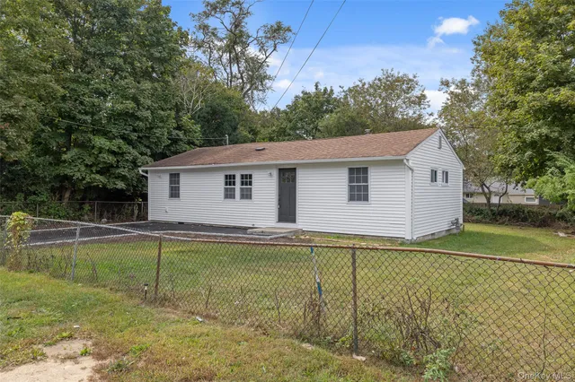 a view of a white house with a big yard and swimming pool
