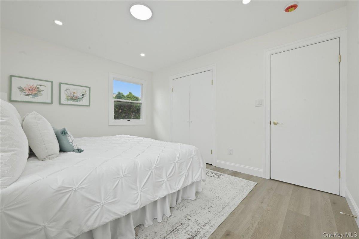 84 North Fordham Road Hicksville, NY 11801 - Photo 12 of 28 a bedroom with a bed and painting on the wall