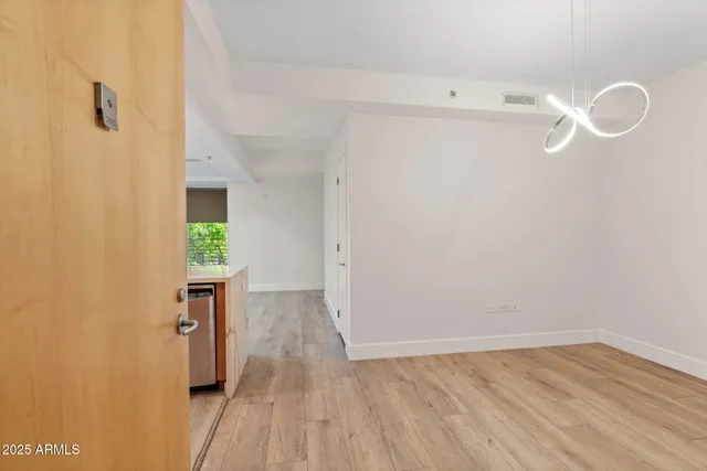 a view of a room with wooden floor and white walls