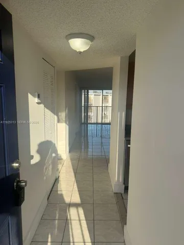 a view of hallway with stairs and wooden floor