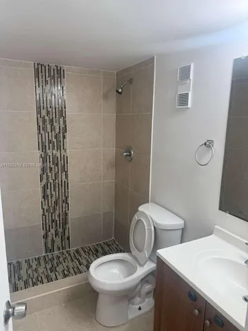 a white toilet sitting next to a bathroom sink