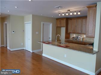 920 South Street, Unit 2 Philadelphia, PA 19147 - Photo 6 of 11 a kitchen with stainless steel appliances granite countertop a sink a stove and a refrigerator