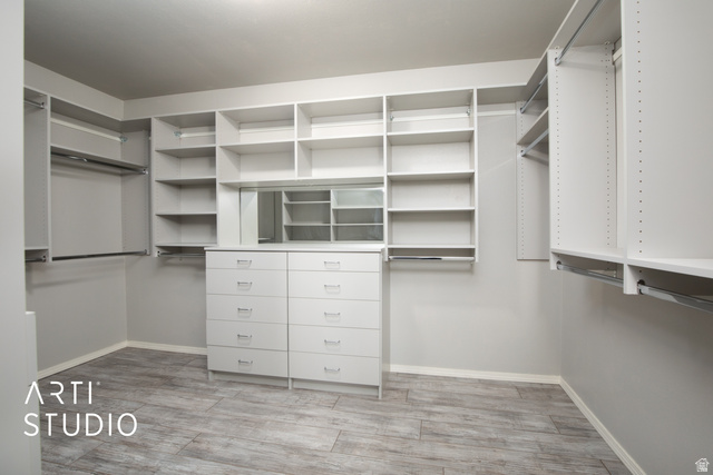 342 South Willow Patch Road Lehi, UT 84043 - Photo 22 of 30 Walk-in closet featuring built-in shelving, hanging rods, an integrated dresser, and a reflective panel