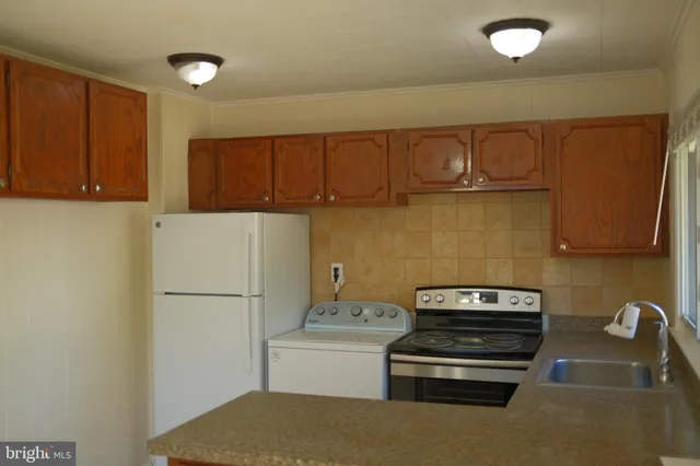 a kitchen with a refrigerator and a stove