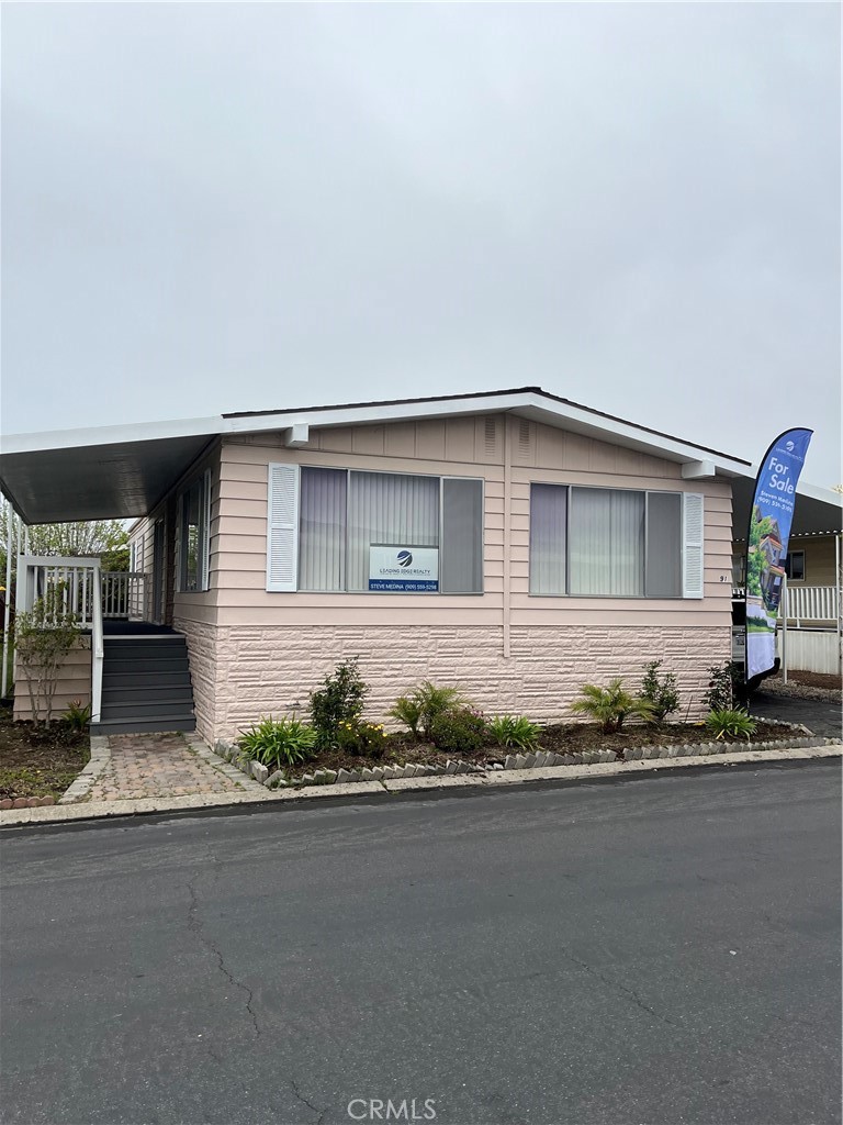 3950 Via Real, Unit 91 Carpinteria, CA 93013 - Photo 2 of 39 a front view of a house with a yard