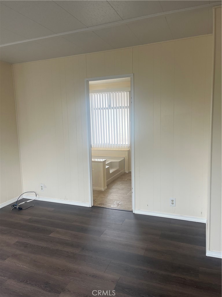 3950 Via Real, Unit 91 Carpinteria, CA 93013 - Photo 21 of 39 an empty room with wooden floor and windows