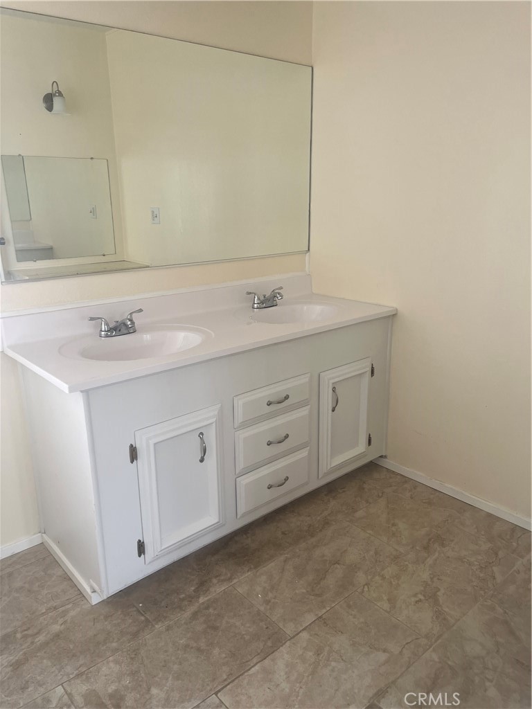 3950 Via Real, Unit 91 Carpinteria, CA 93013 - Photo 23 of 39 a bathroom with a double vanity sink and mirror