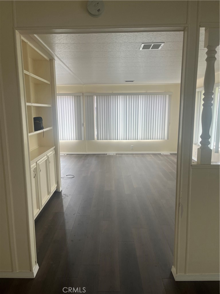 3950 Via Real, Unit 91 Carpinteria, CA 93013 - Photo 3 of 39 a view of an empty room with wooden floor and a window