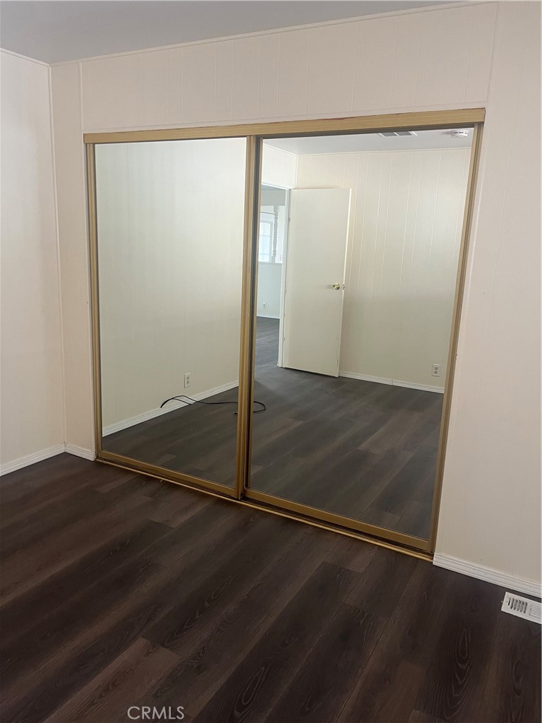 3950 Via Real, Unit 91 Carpinteria, CA 93013 - Photo 34 of 39 an empty room with wooden floor and door