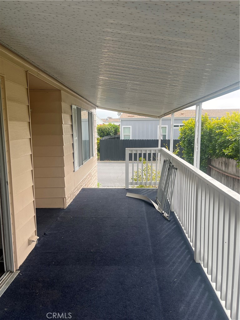 3950 Via Real, Unit 91 Carpinteria, CA 93013 - Photo 9 of 39 a view of porch with floor to ceiling window and wooden floor
