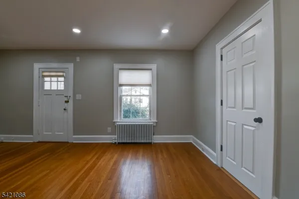 a view of a hallway with an empty room and a window