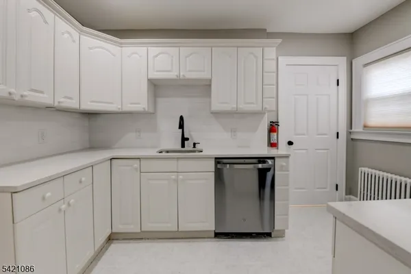 a kitchen with sink a stove and refrigerator