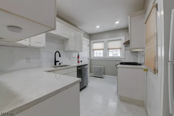 a kitchen with a stove and a refrigerator